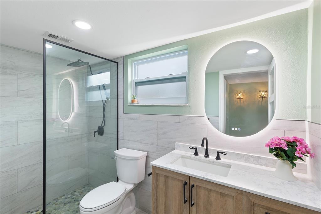 3409 Springfield Drive Holiday, FL 34691 - Photo 17 of 37 a bathroom with a sink vanity mirror and toilet