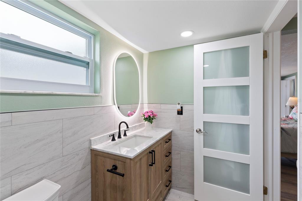 3409 Springfield Drive Holiday, FL 34691 - Photo 18 of 37 a bathroom with a sink and a mirror