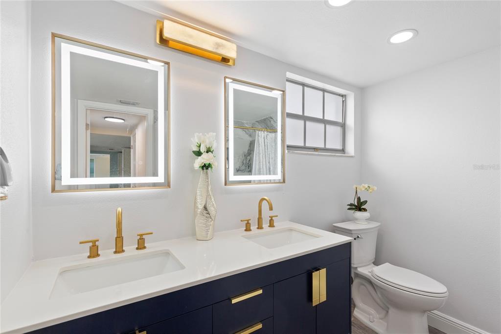 3409 Springfield Drive Holiday, FL 34691 - Photo 24 of 37 a bathroom with a toilet a sink and mirror