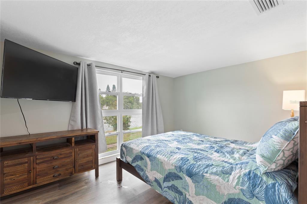 3409 Springfield Drive Holiday, FL 34691 - Photo 26 of 37 a bedroom with a bed and flat screen tv