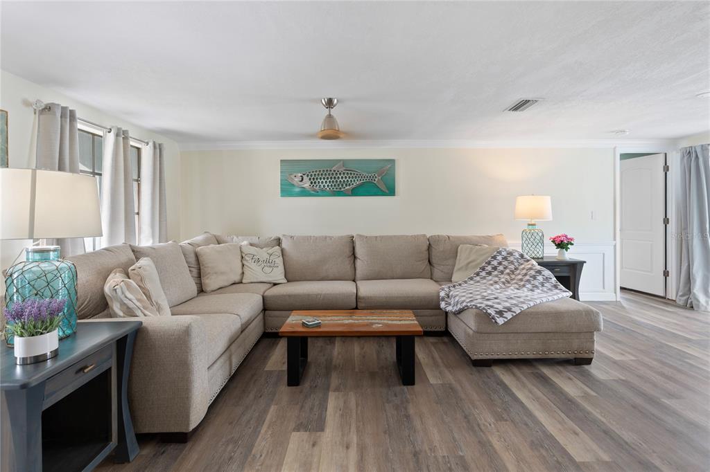 3409 Springfield Drive Holiday, FL 34691 - Photo 3 of 37 a living room with furniture and a wooden floor