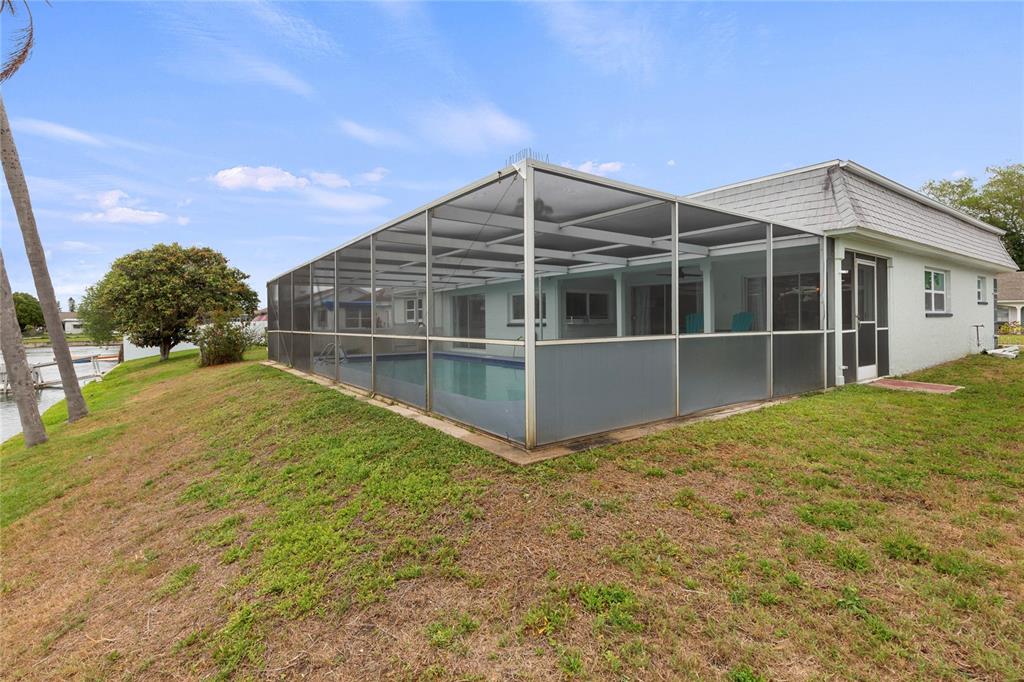 3409 Springfield Drive Holiday, FL 34691 - Photo 33 of 37 a view of a house with a backyard and a tree
