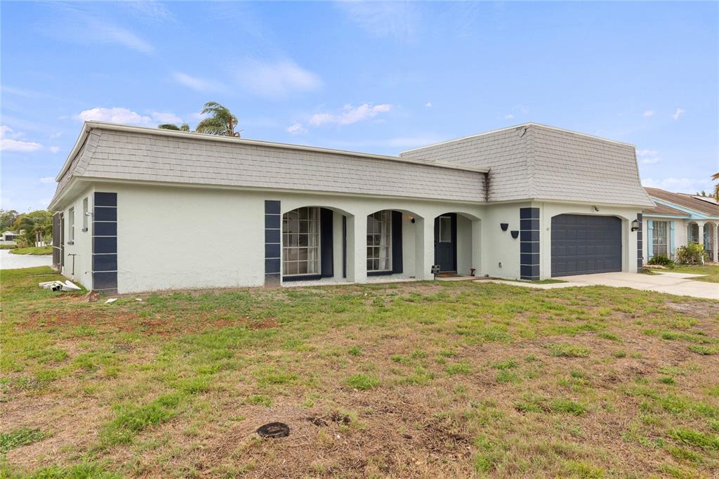 3409 Springfield Drive Holiday, FL 34691 - Photo 36 of 37 a house with yard in front of it