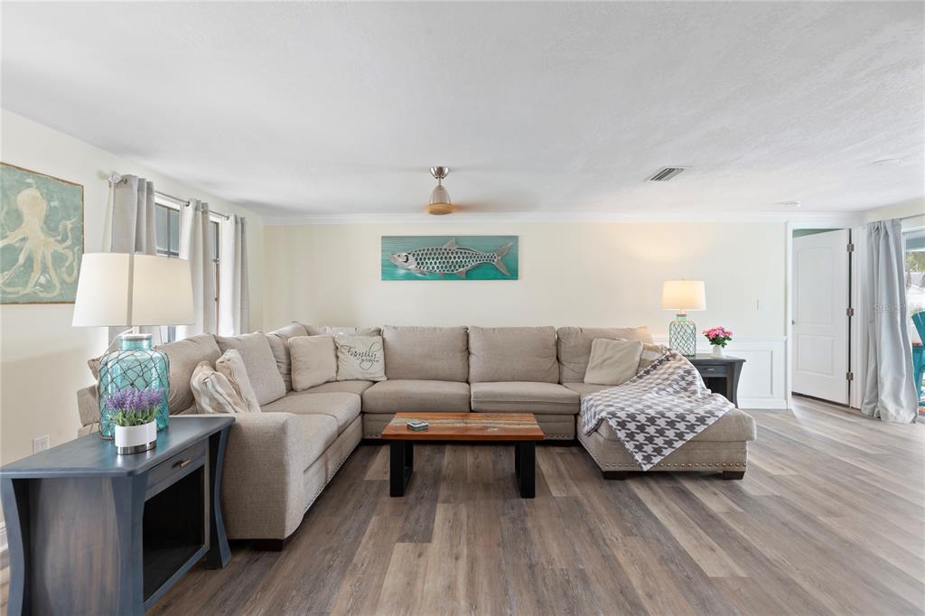 3409 Springfield Drive Holiday, FL 34691 - Photo 6 of 37 a living room with furniture and a wooden floor