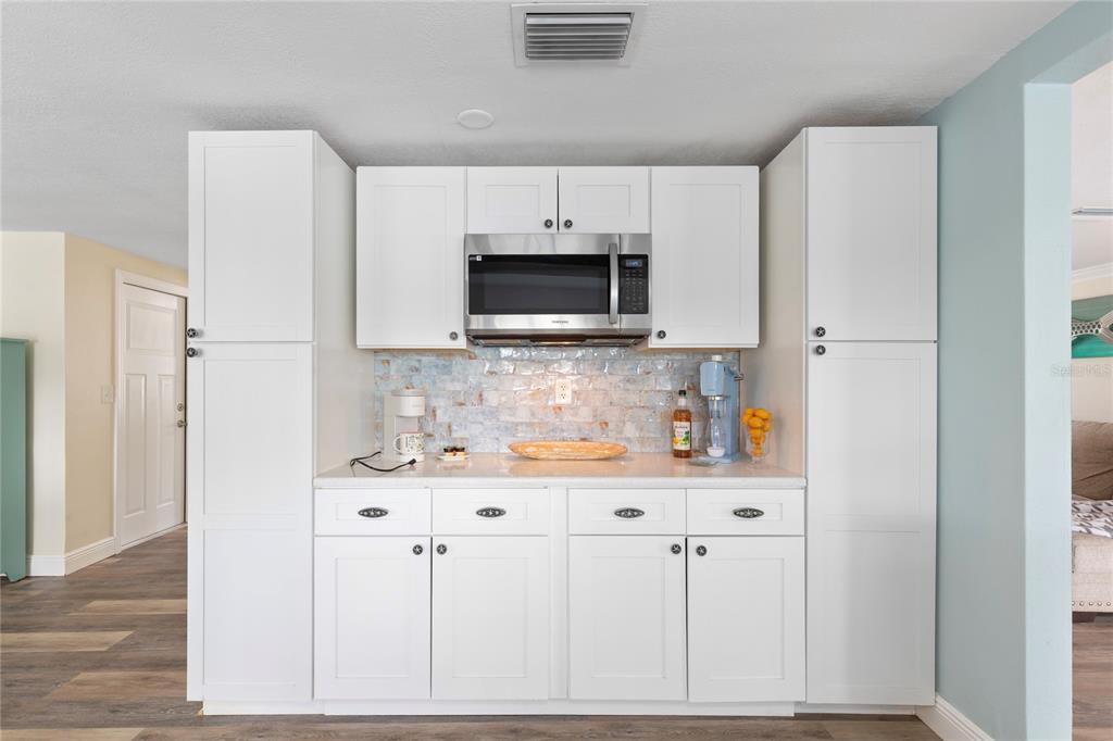3409 Springfield Drive Holiday, FL 34691 - Photo 7 of 37 a kitchen with granite countertop white cabinets and stainless steel appliances