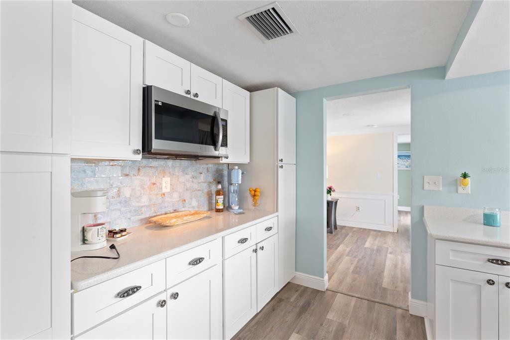 3409 Springfield Drive Holiday, FL 34691 - Photo 10 of 37 a kitchen with a sink a microwave and cabinets