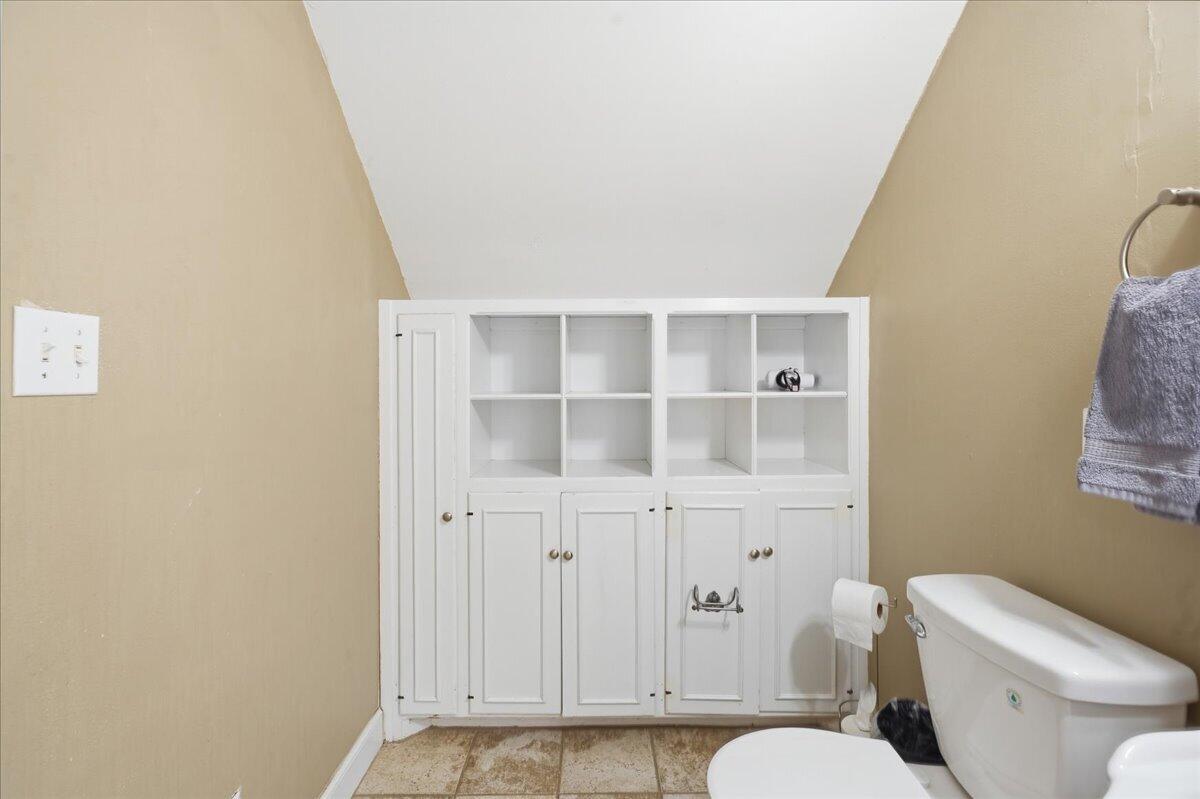 2702 20th Street Lubbock, TX 79410 - Photo 28 of 34 a white toilet sitting next to a bathroom sink