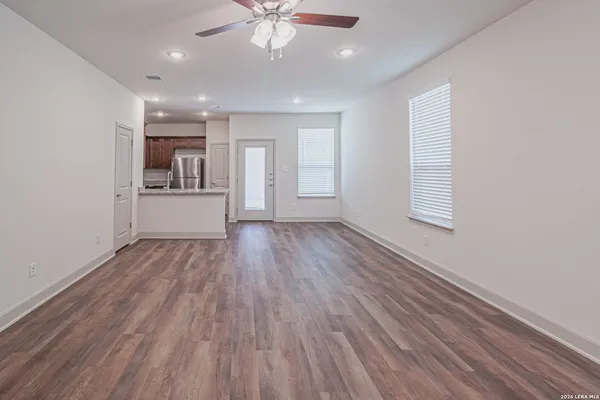a view of kitchen with wooden floor and electronic appliances