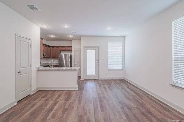 a kitchen with a refrigerator and a stove top oven