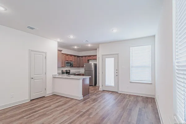 a kitchen with stainless steel appliances granite countertop a refrigerator and a stove top oven