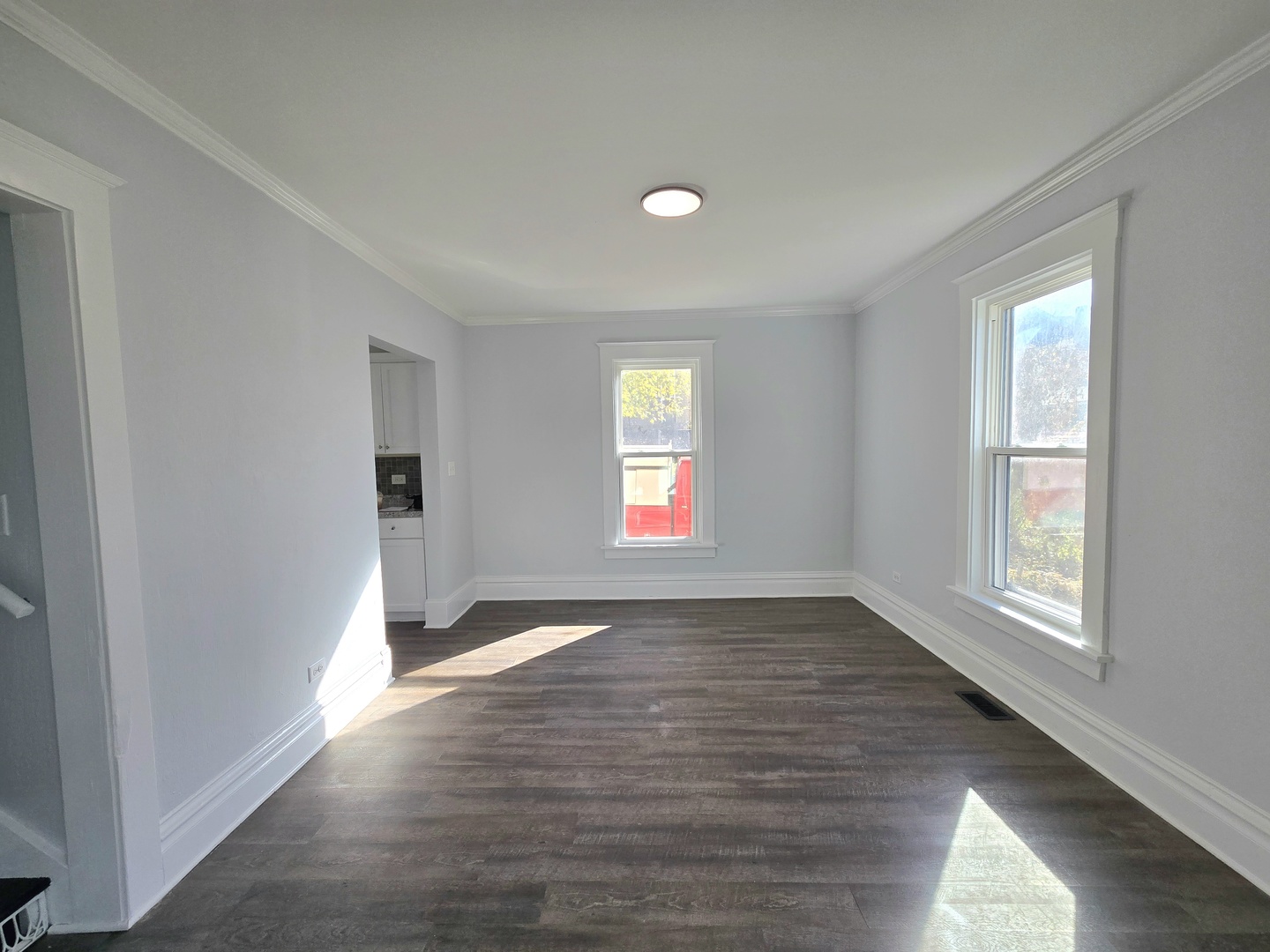 328 Rosewood Avenue Aurora, IL 60505 - Photo 7 of 24 an empty room with wooden floor and windows