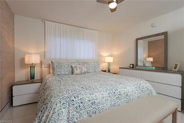 a bedroom with a bed and a lamp