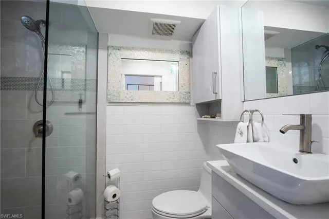 a bathroom with a sink toilet and shower