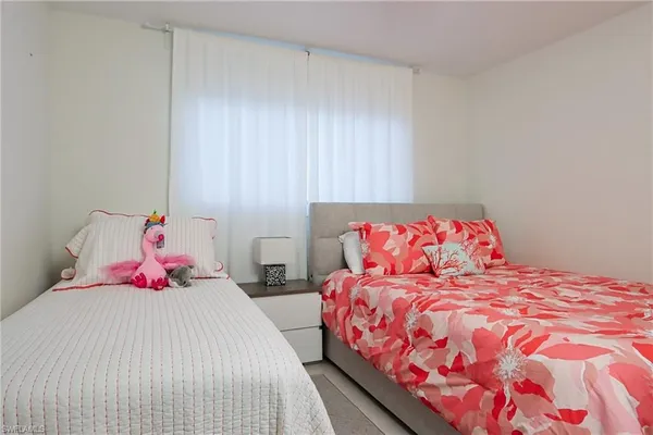 a bedroom with a bed and a potted plant