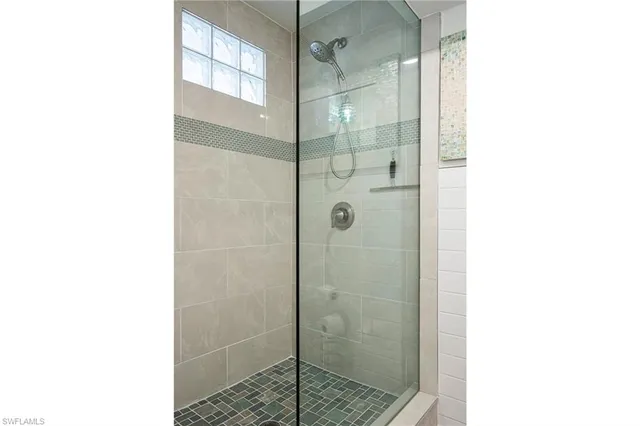 a bathroom with a shower and a mirror