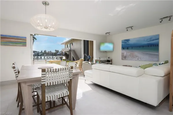 a living room with furniture and a large mirror