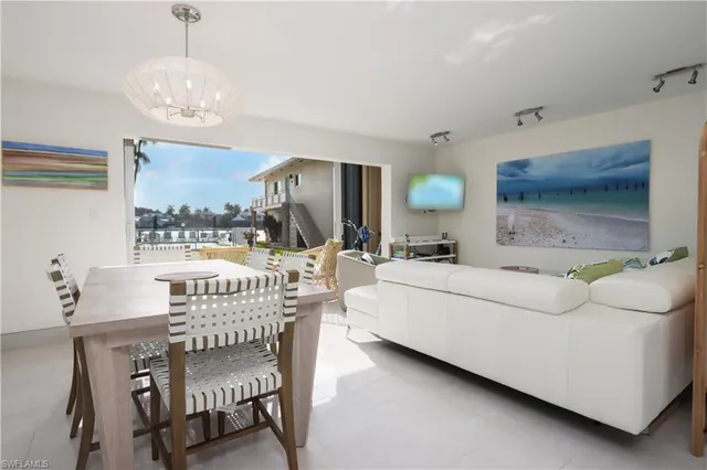 a living room with furniture and a large mirror