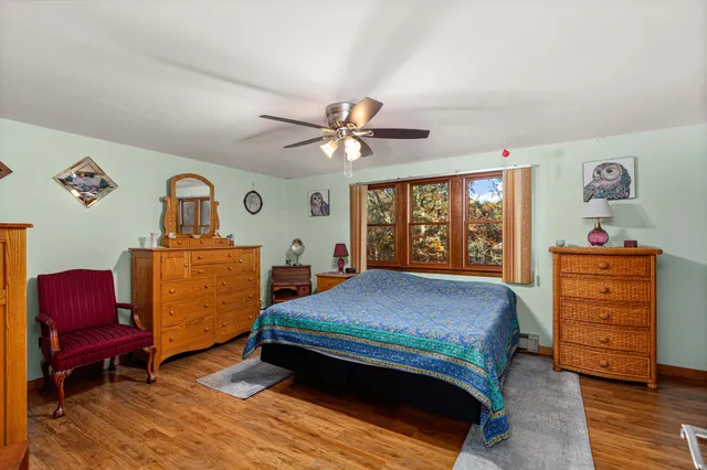 a bedroom with a bed and a dresser in it