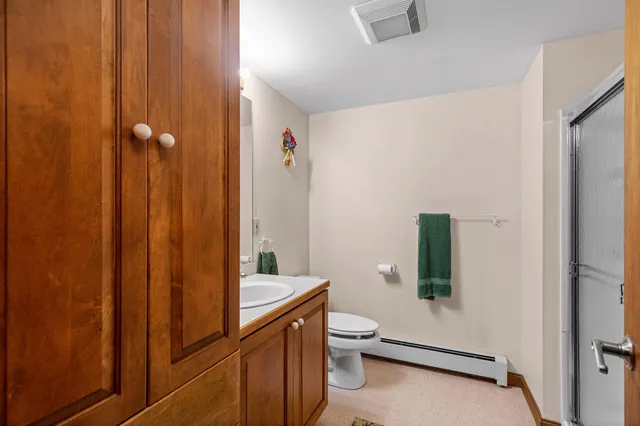 a bathroom with a toilet sink and shower