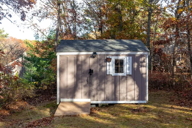 a view of backyard with small cabin