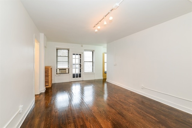 725 West Sheridan Road, Unit 203 Chicago, IL 60613 - Photo 2 of 10 a view of an empty room with wooden floor and a window