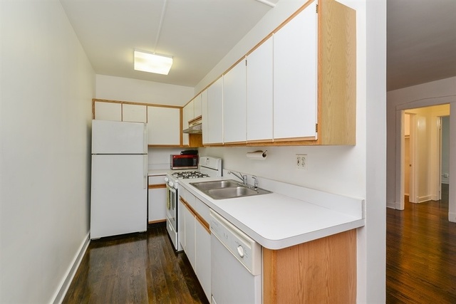 725 West Sheridan Road, Unit 203 Chicago, IL 60613 - Photo 3 of 10 a kitchen with a sink a stove a refrigerator and cabinets