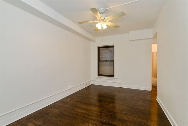725 West Sheridan Road, Unit 203 Chicago, IL 60613 - Photo 5 of 10 a view of an empty room with wooden floor and a window