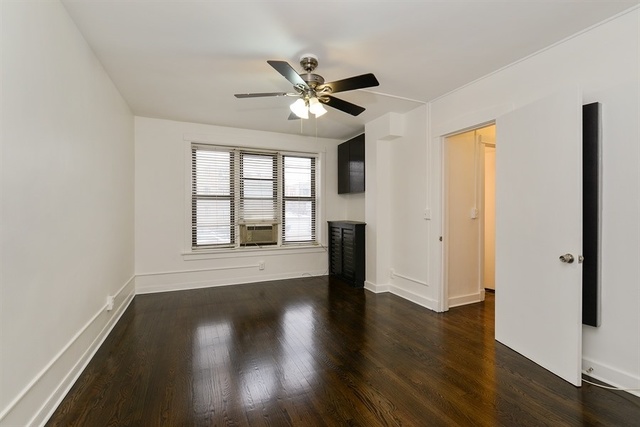 725 West Sheridan Road, Unit 203 Chicago, IL 60613 - Photo 7 of 10 a view of an empty room with wooden floor and a window