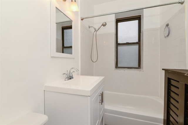 725 West Sheridan Road, Unit 203 Chicago, IL 60613 - Photo 8 of 10 a bathroom with a sink toilet and shower