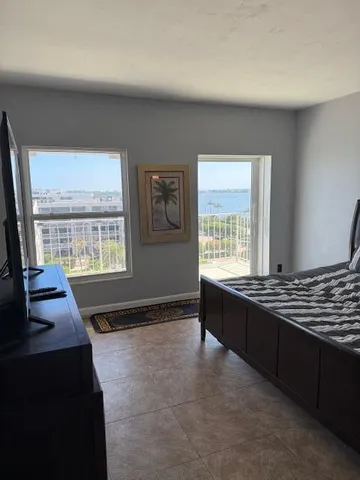 a bedroom with a bed and a television