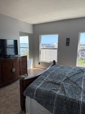 a bedroom with a bed and a potted plant