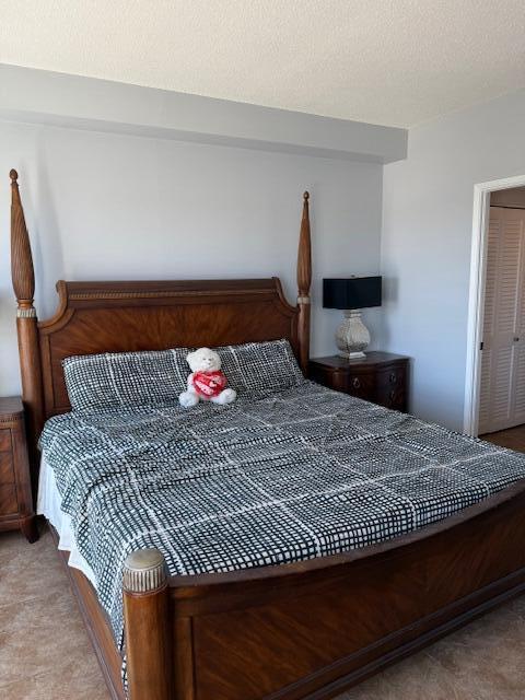 3230 South Ocean Boulevard, Unit E610 Palm Beach, FL 33480 - Photo 27 of 31 a bedroom with a bed and a potted plant