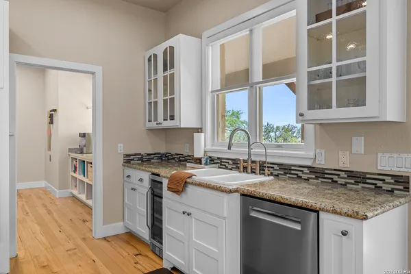 a kitchen with a sink stove and cabinets