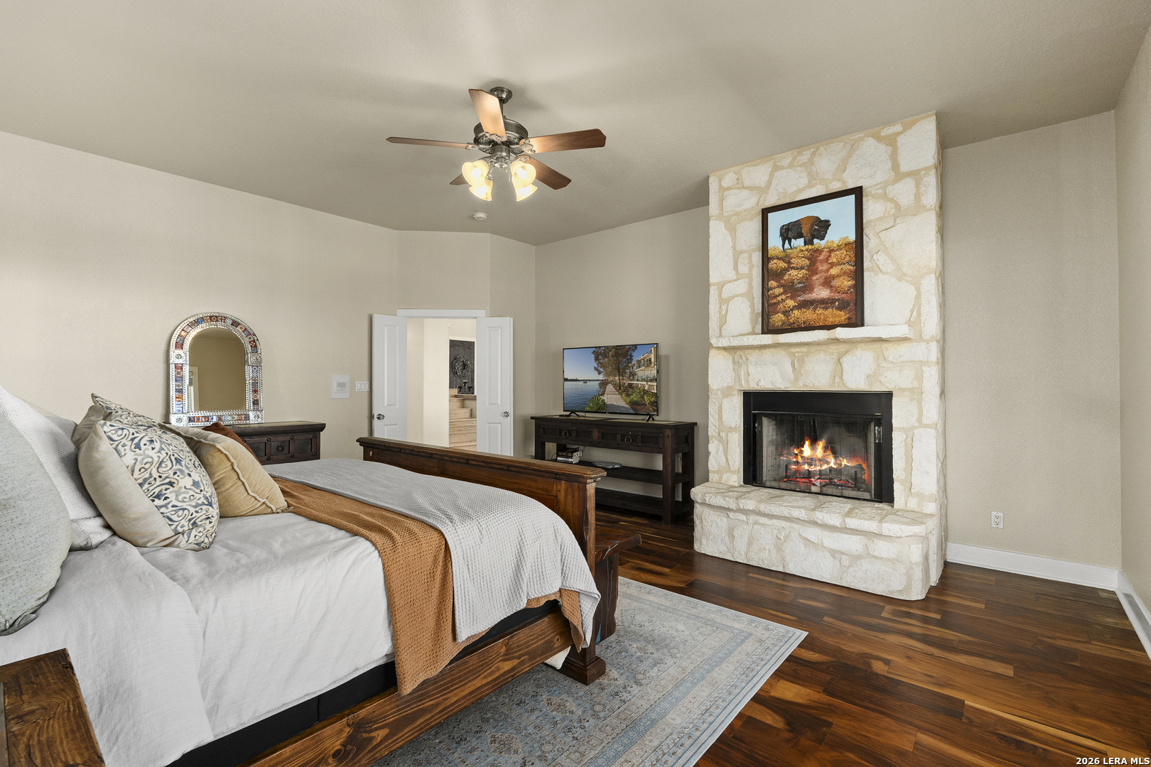 140 Kuntz Run Bulverde, TX 78163 - Photo 17 of 49 a bedroom with a bed and a fireplace