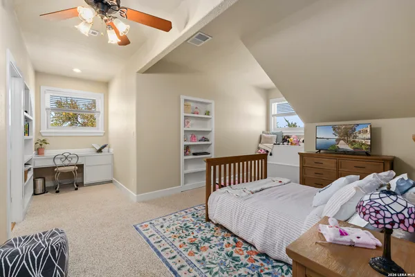 a bedroom with furniture and a window