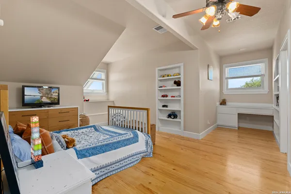 a bedroom with furniture and wooden floor