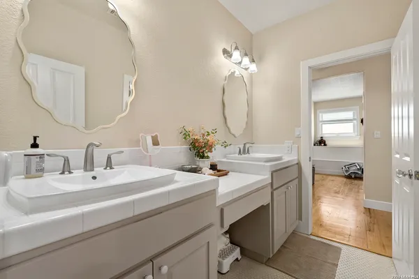 a bathroom with a double vanity sink mirror and