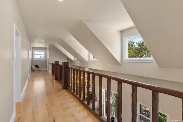 a view of hallway with wooden floor and stairs