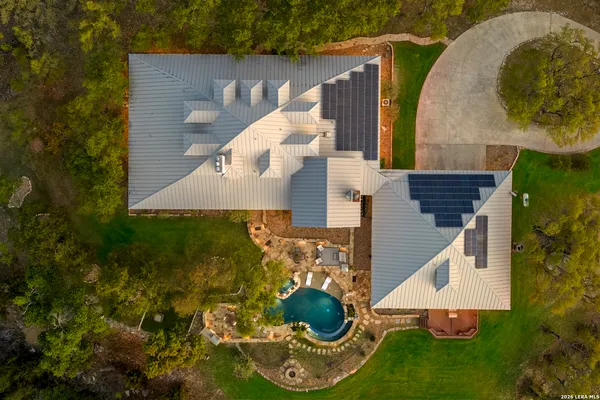 an aerial view of a house with outdoor space and a lake view