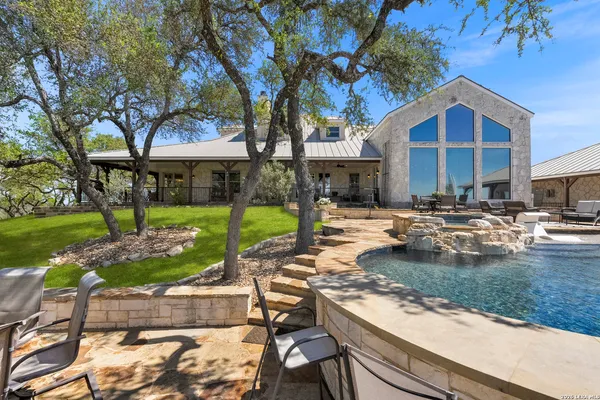 a view of a house with backyard and sitting area