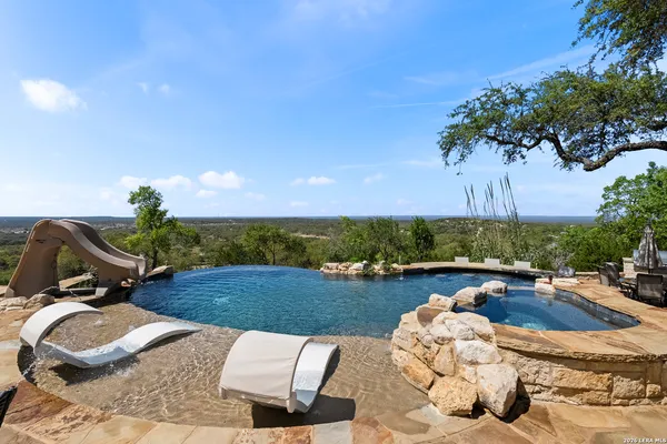 a view of a swimming pool and lounge chair