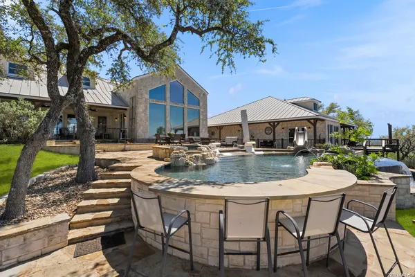 a patio with a table and chairs under an umbrella