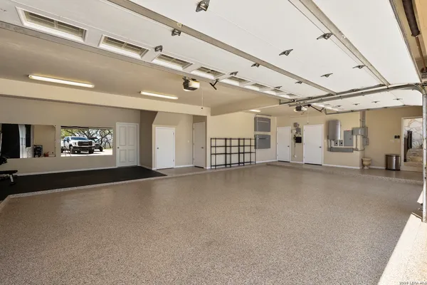 a living room with furniture a chandelier and a table