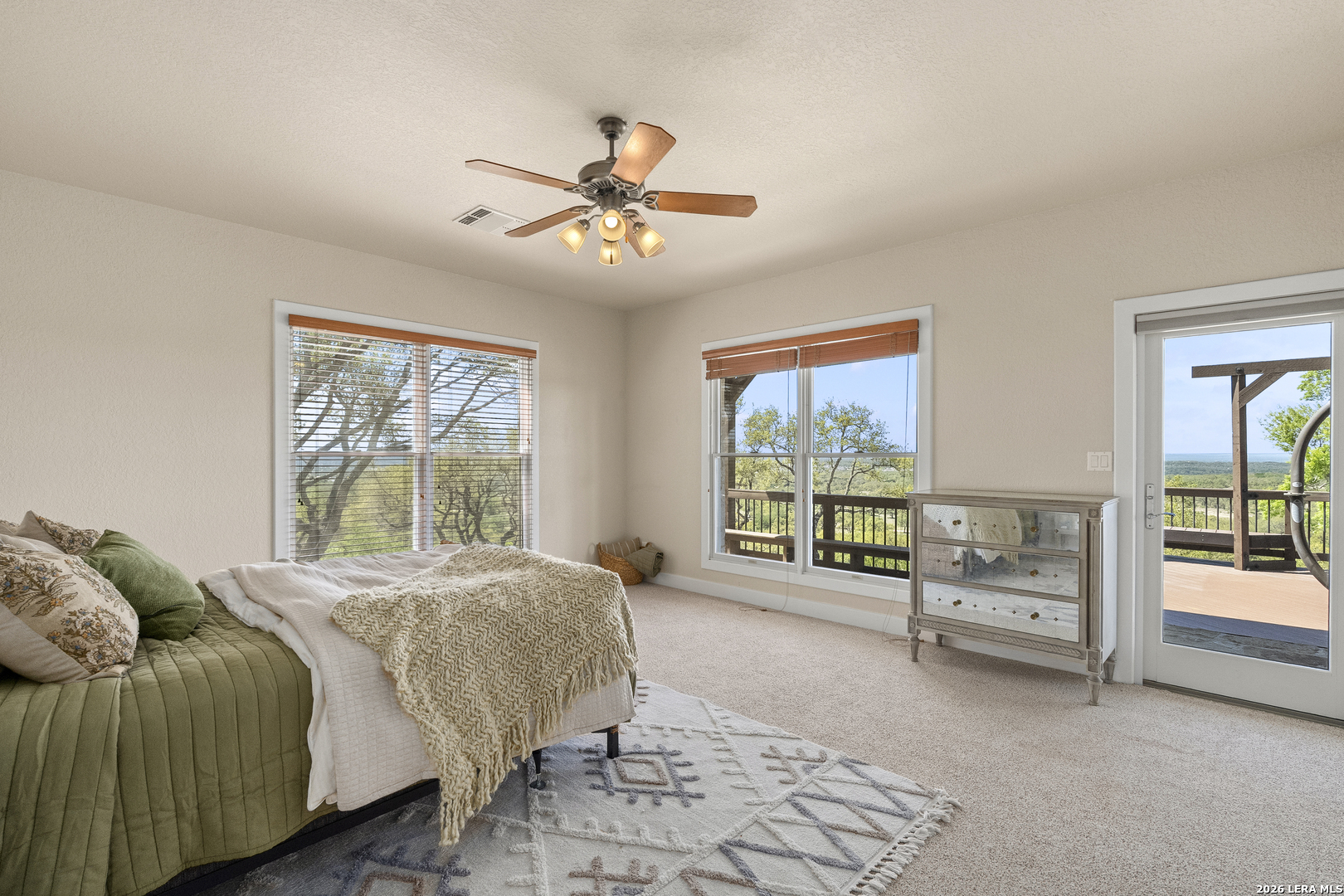 140 Kuntz Run Bulverde, TX 78163 - Photo 36 of 49 a spacious bedroom with a bed and a large window