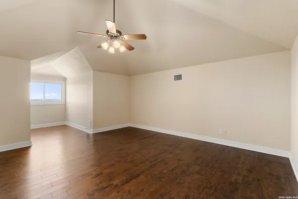 a view of a balcony with chairs and wooden floor