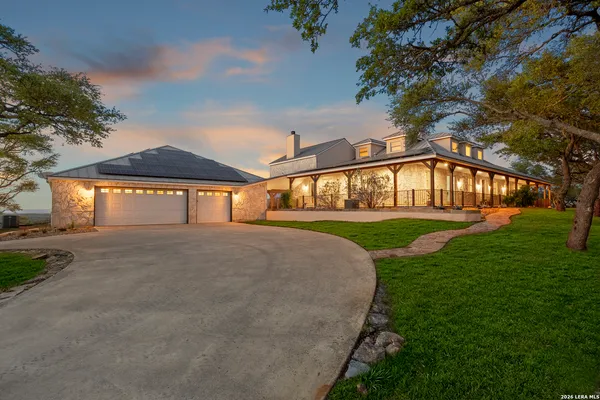 a view of an house with backyard and tree s