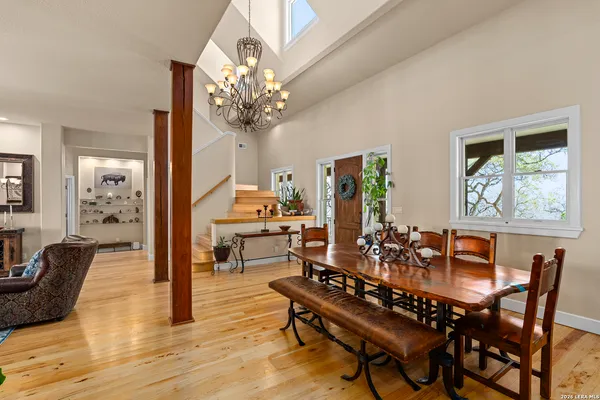 a view of a dining room with furniture wooden floor and chandelier
