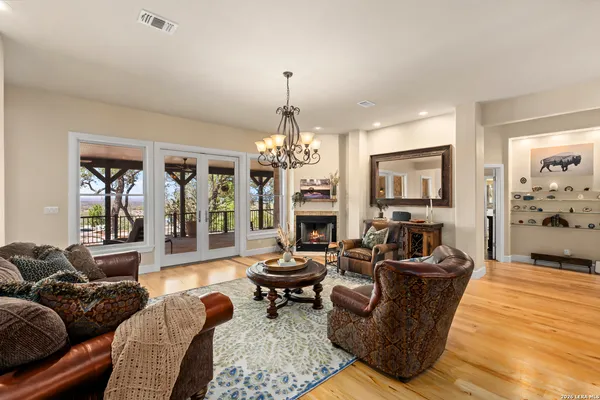 a living room with fireplace furniture and a chandelier