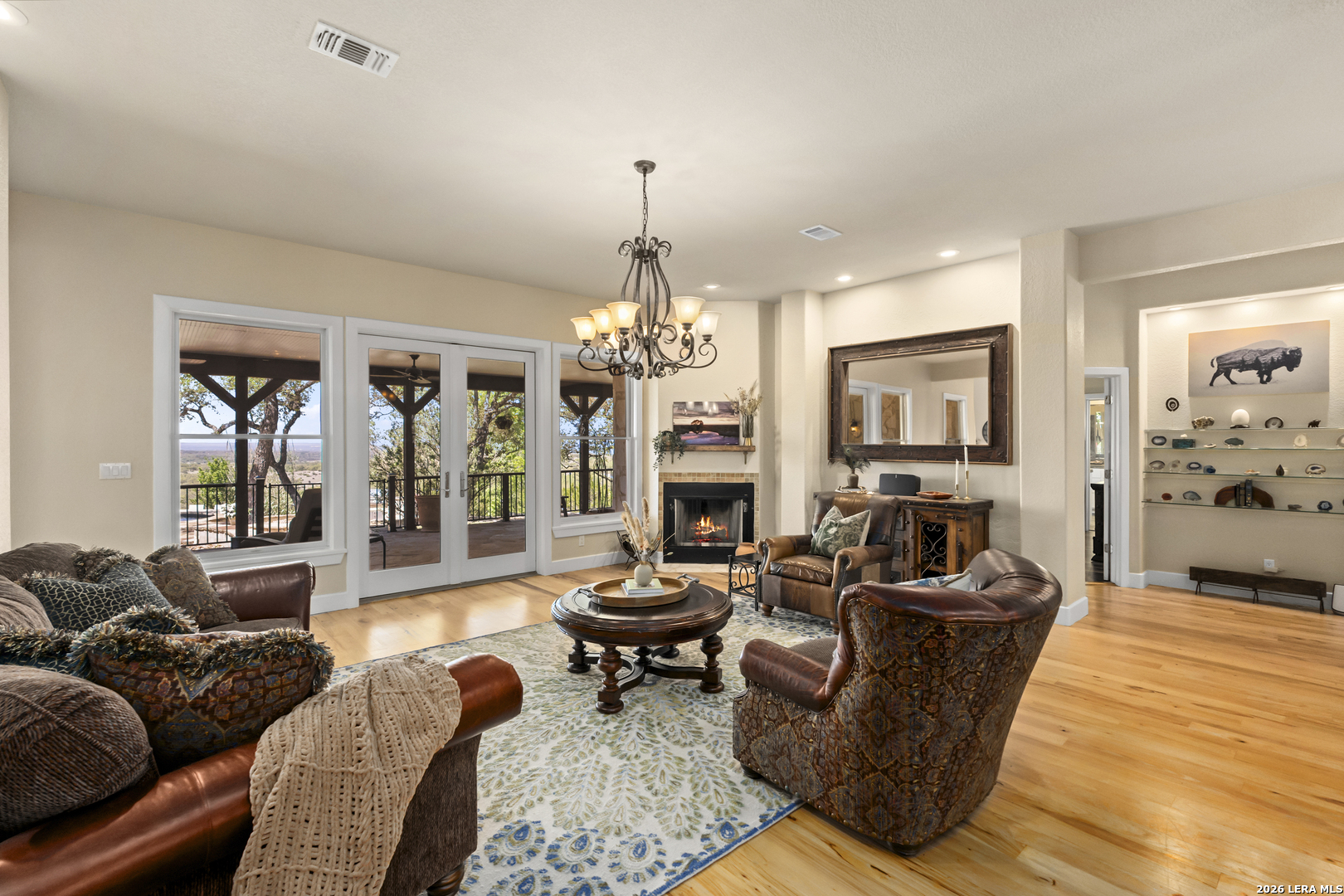 140 Kuntz Run Bulverde, TX 78163 - Photo 9 of 49 a living room with fireplace furniture and a chandelier