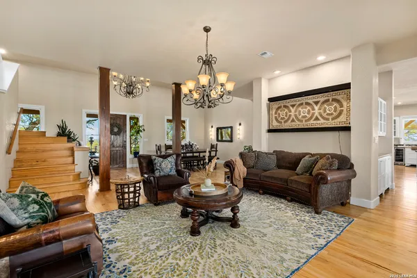 a living room with furniture and a chandelier